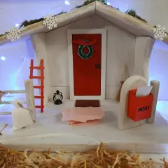Winterliche Deko mit Weihnachtshaus, Schneeflocken und Lichterkette. Perfekt für Kita-Angebote im Winter.