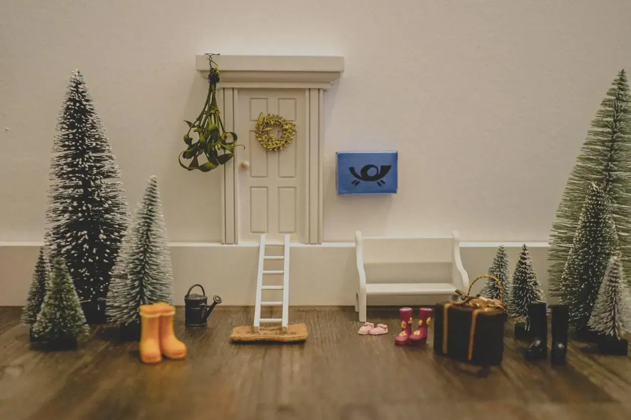 Kleine Weihnachtsbäume, eine Leiter und Stiefel vor einer Tür – tolle Wichtel Ideen für den Kindergarten, um eine winterliche Szene zu gestalten.