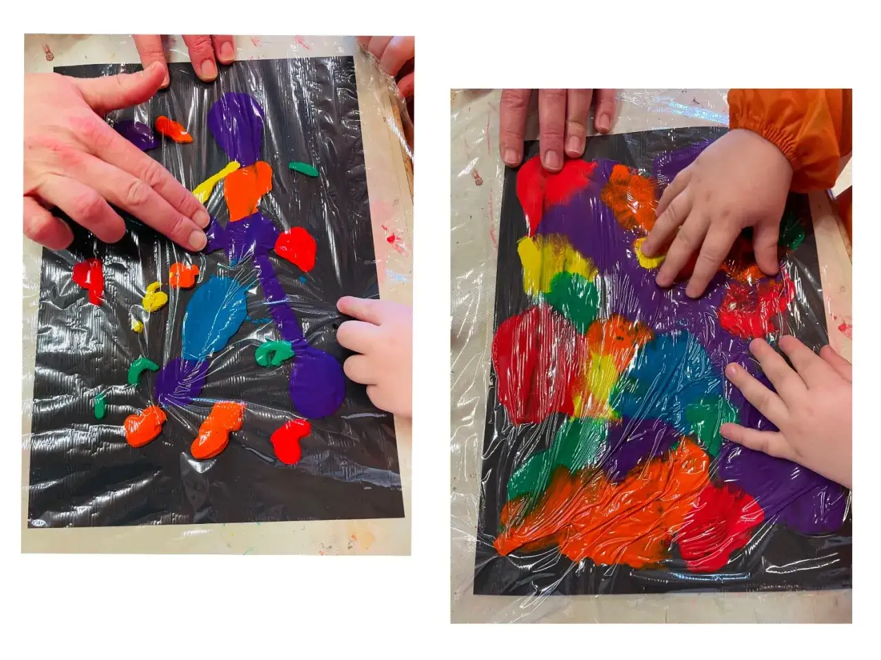 Kreatives Malen mit Kindern: Fingerfarben auf schwarzem Papier unter Folie. Bunte Kleckse werden mit Fingern zu abstrakten Formen verwischt.